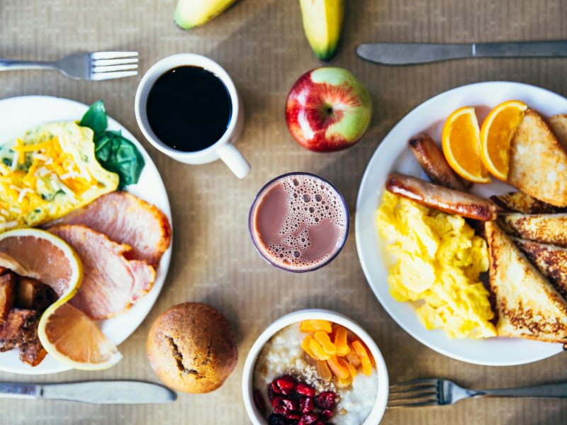 Vibrant breakfast with eggs, fruits, toast, and coffee for a wholesome start.